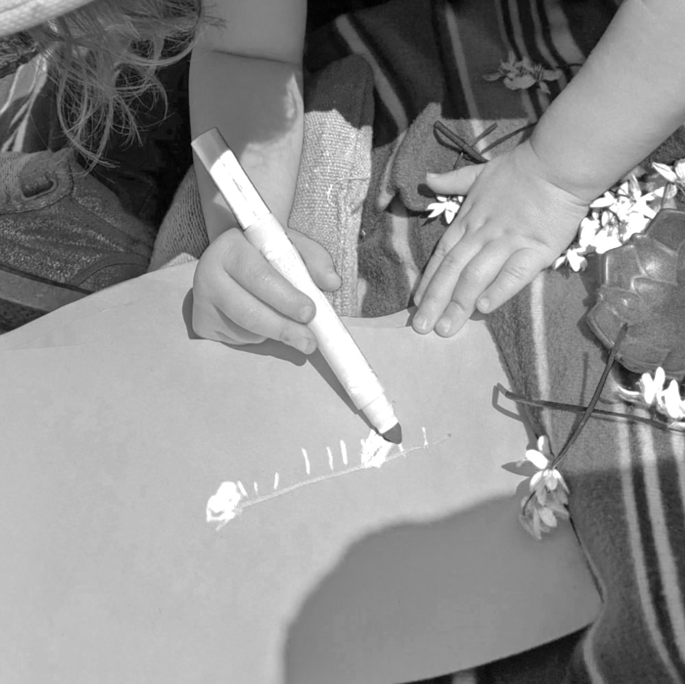 child writing with a marker